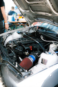 the engine of a car with a man standing next to it