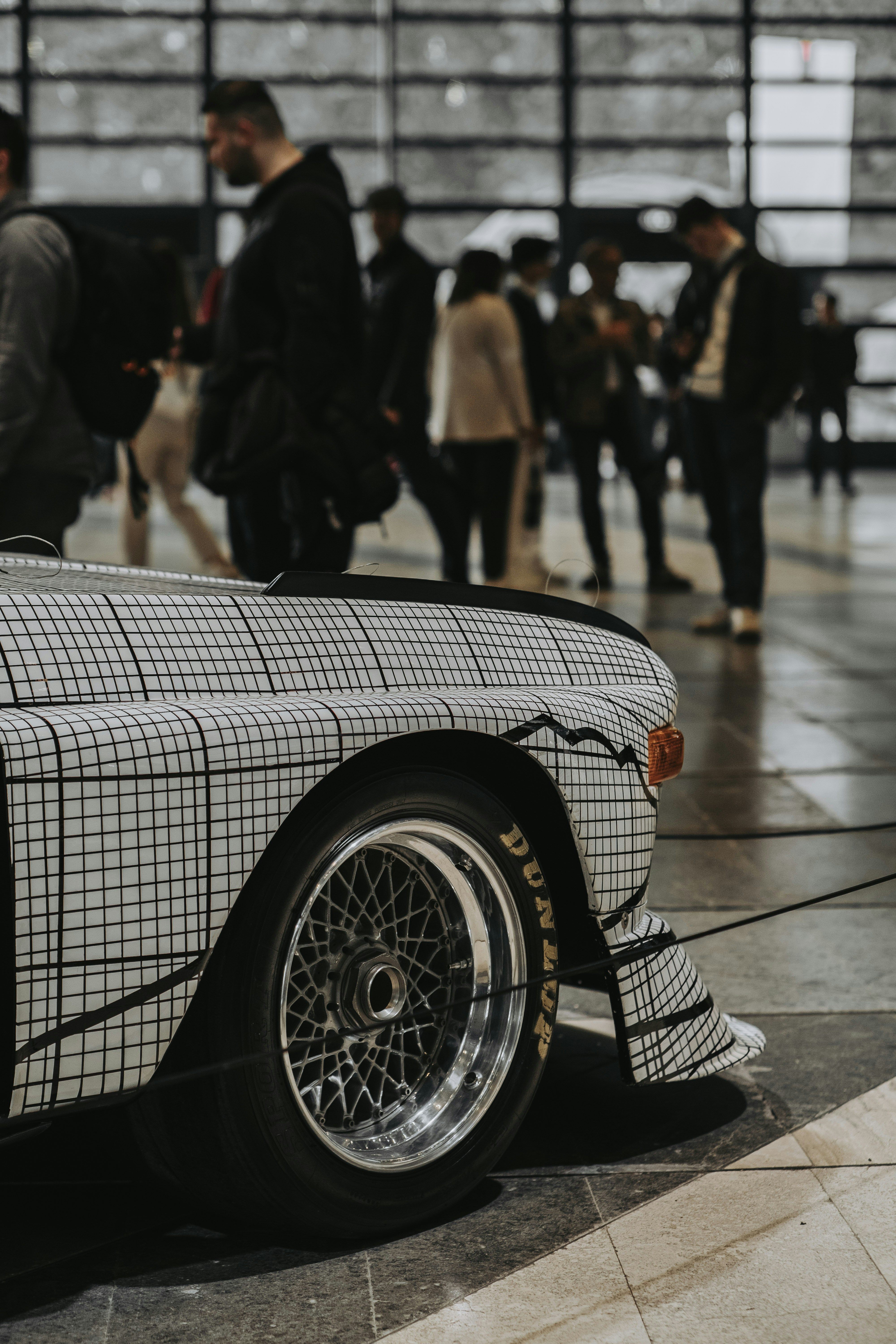 a black and white checkered car parked in a building