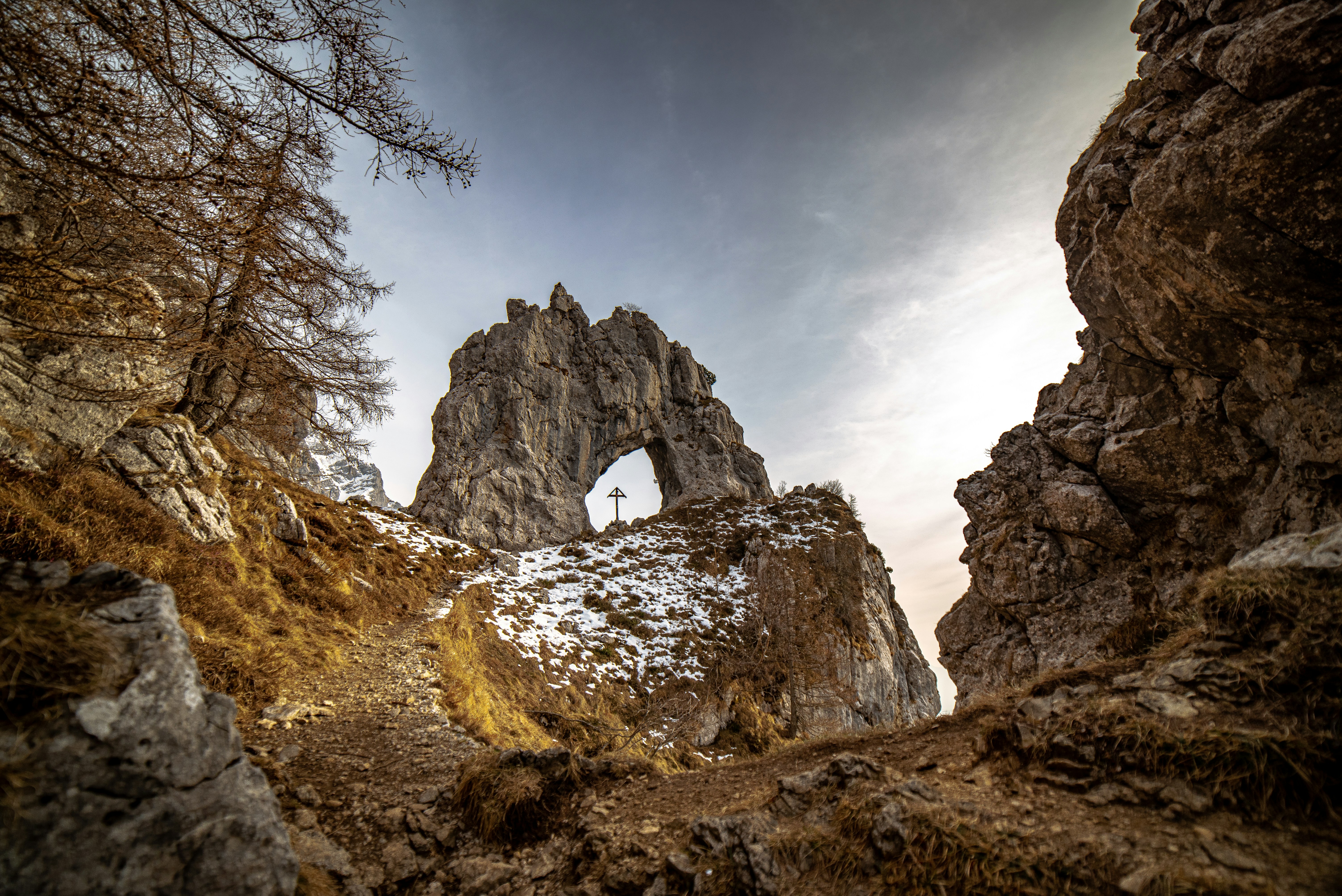 eine felsige Landschaft mit einem kleinen Bogen in der Mitte