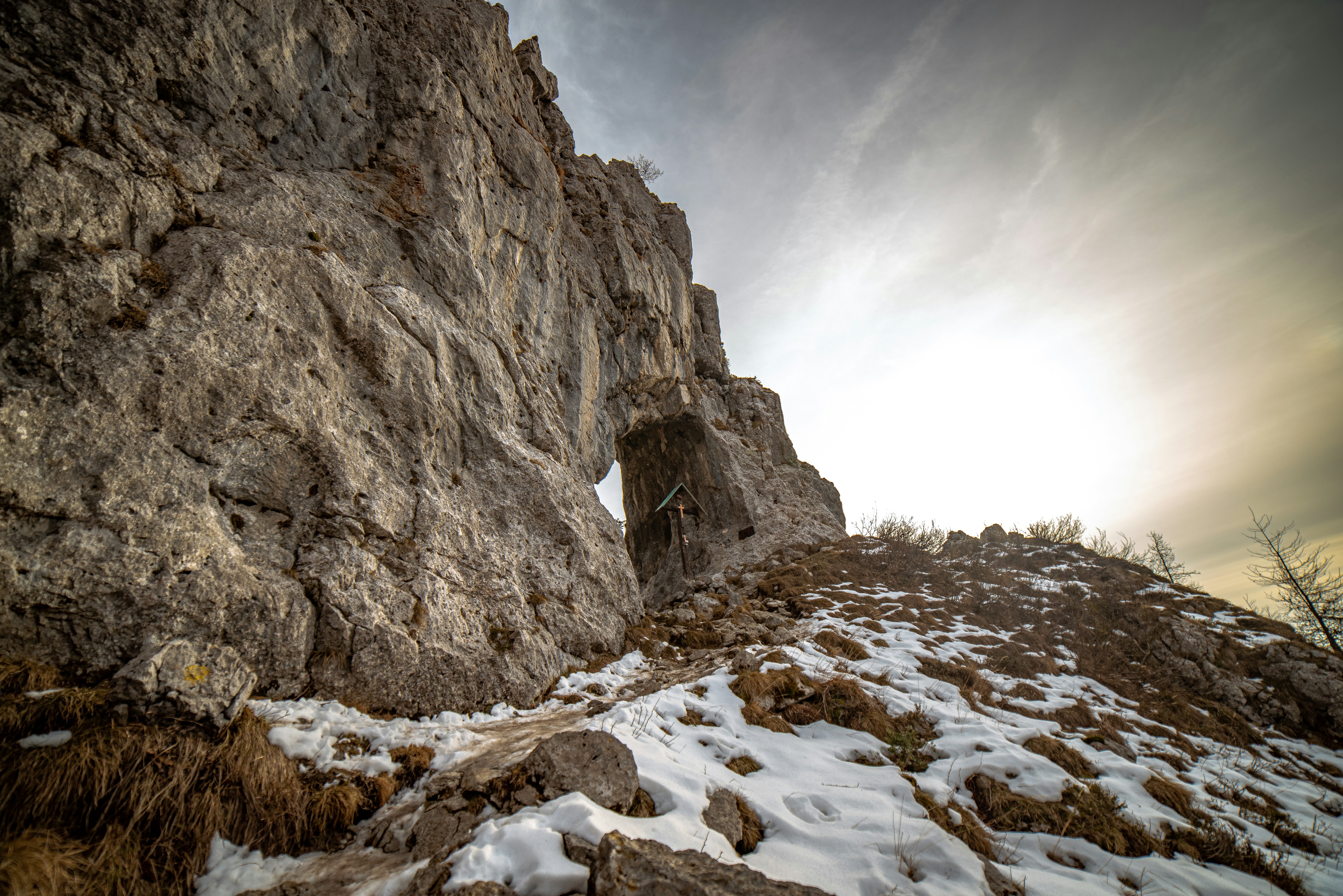 a person climbing up a snow covered mountain