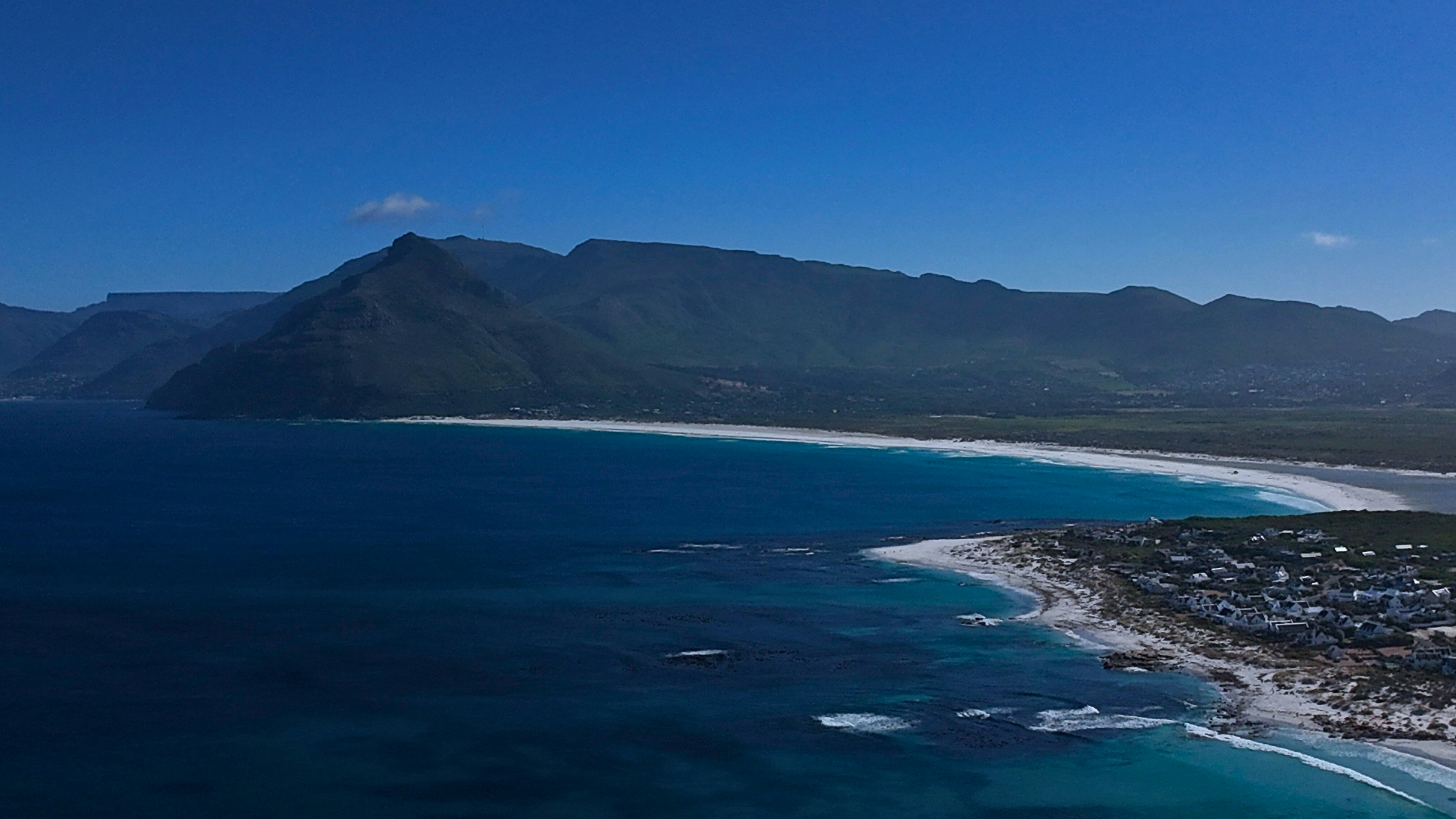 a bird's eye view of a beach and mountains