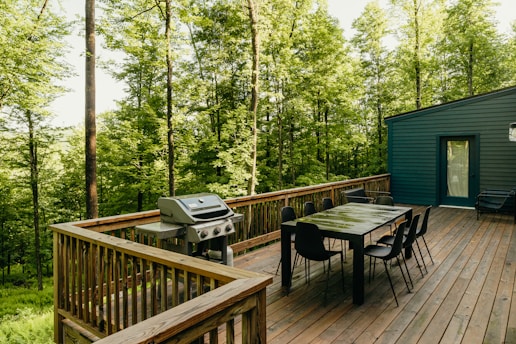 a wooden deck with a table and chairs on it