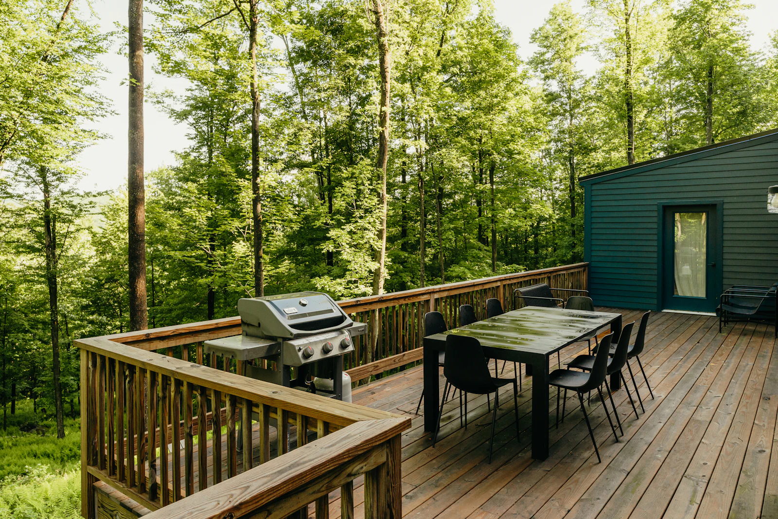 A wooden deck with a dining table and chairs