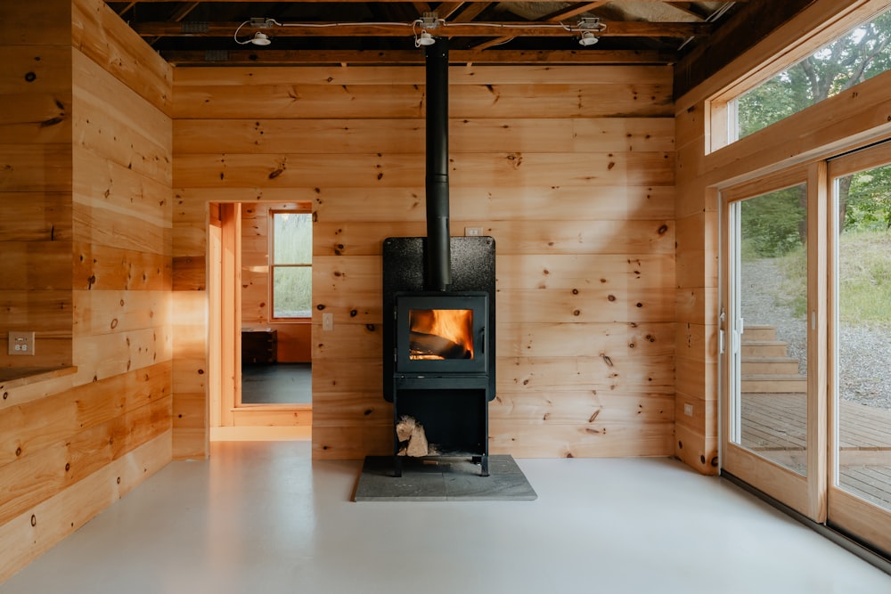 a wood burning stove inside of a wooden cabin