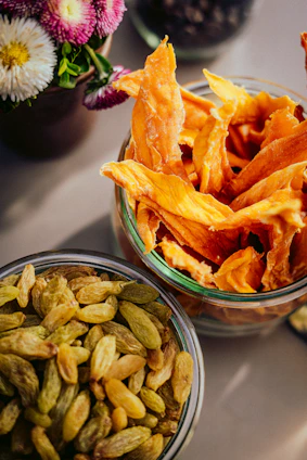 Dried mango slices and raisins in glass jars