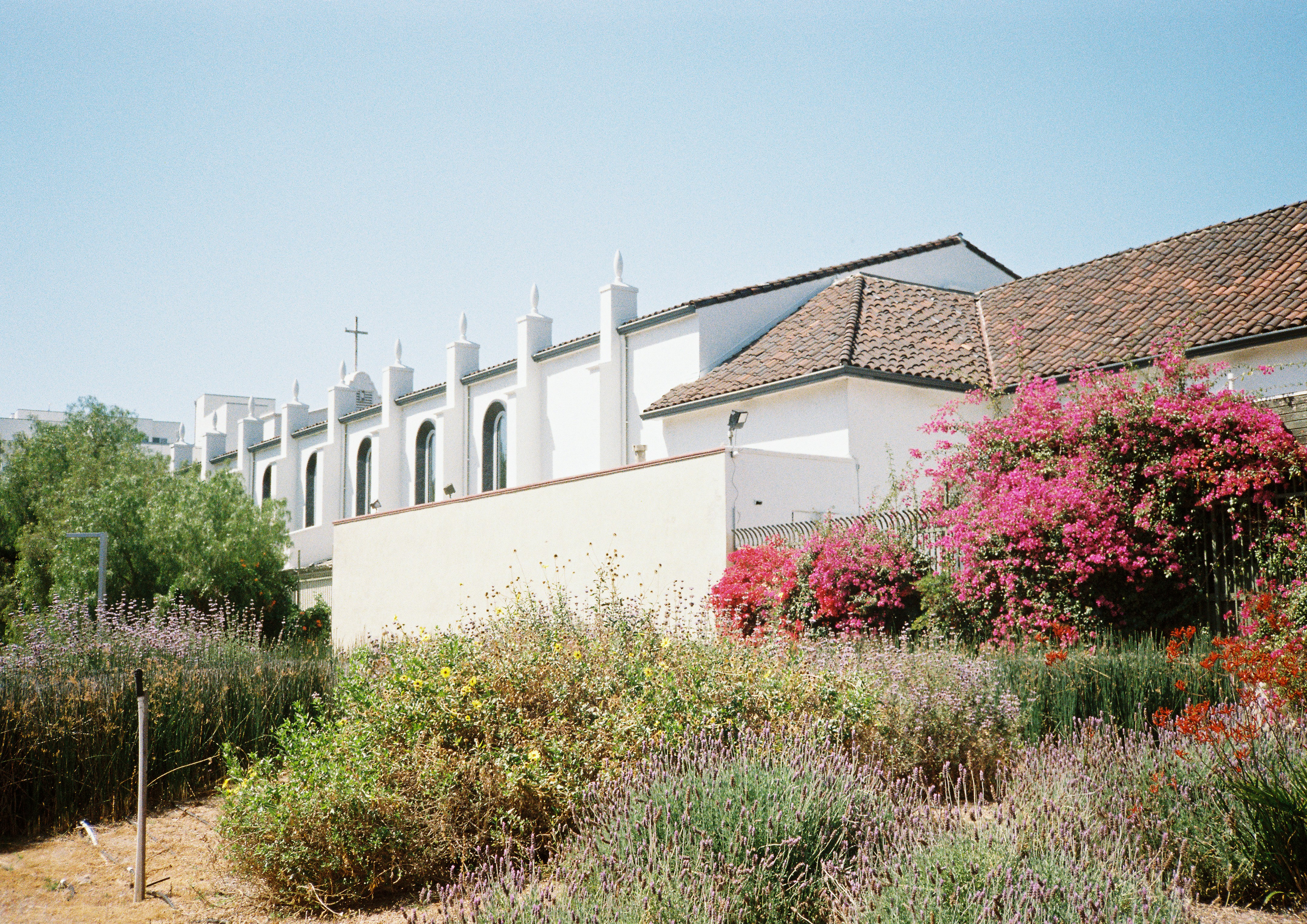 a building with a lot of flowers in front of it