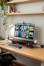a computer monitor sitting on top of a wooden desk