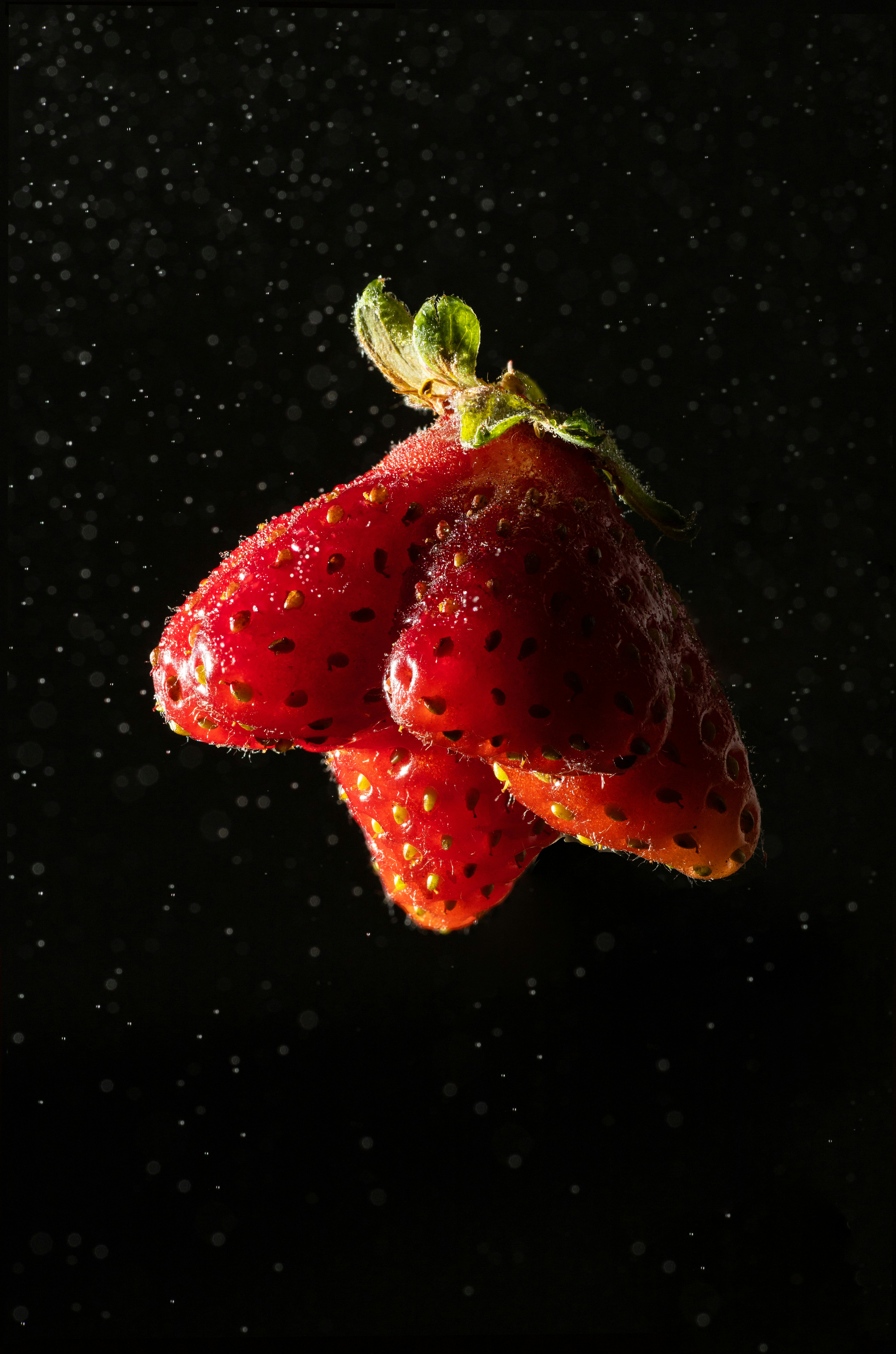 a couple of strawberries sitting on top of a table