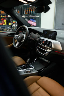 the interior of a car with a dashboard and steering wheel