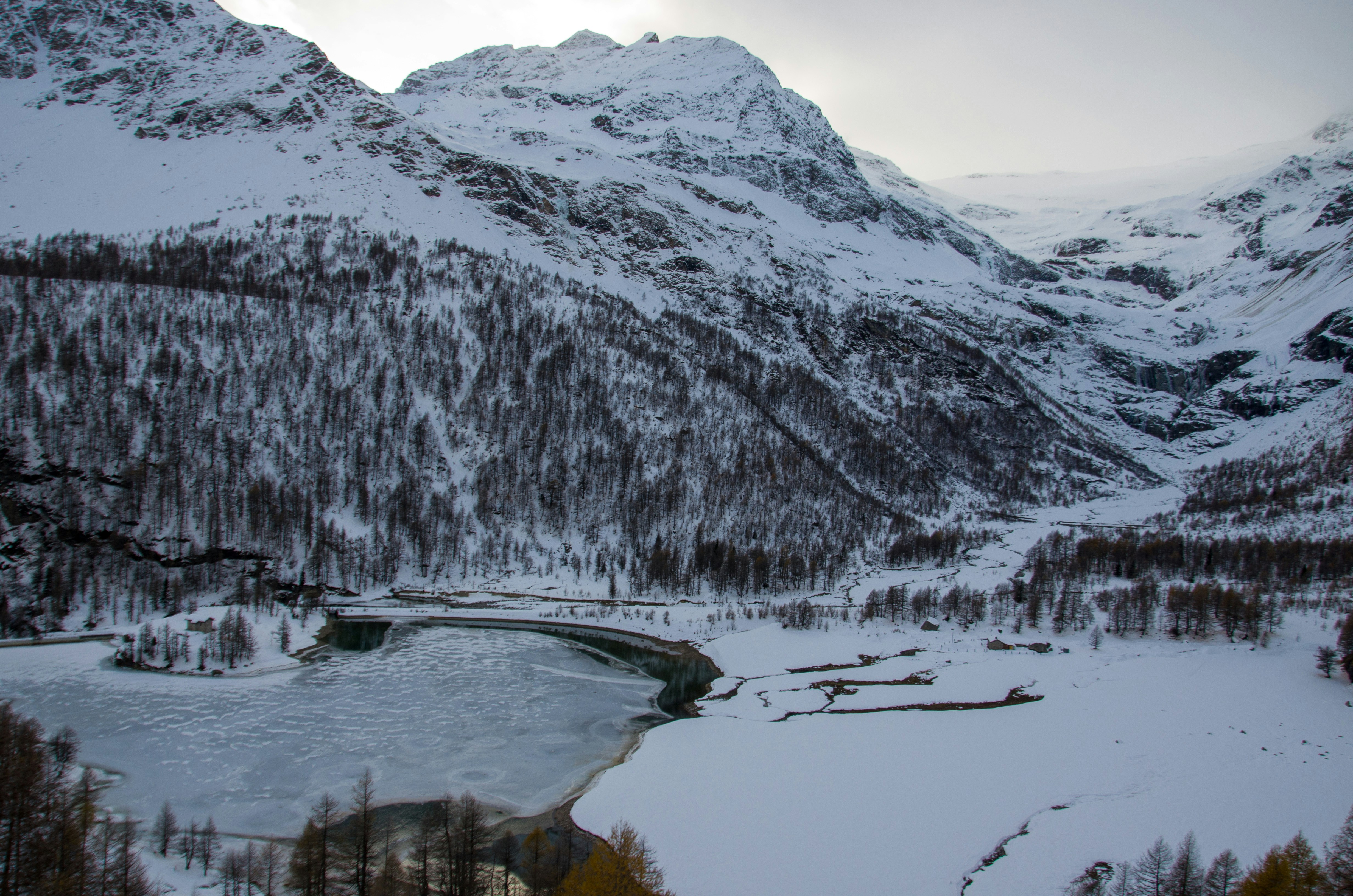 a snow covered mountain with a river running through it
