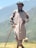 A man with a cane standing in a field