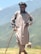A man with a cane standing in a field