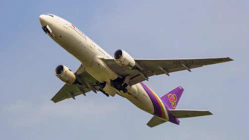 a large jetliner flying through a blue sky