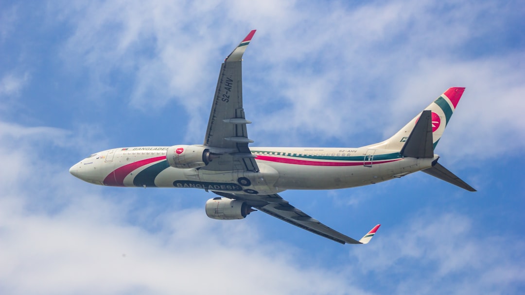 a large jetliner flying through a blue cloudy sky, Biman bangladesh Airlines Boeing 737-800