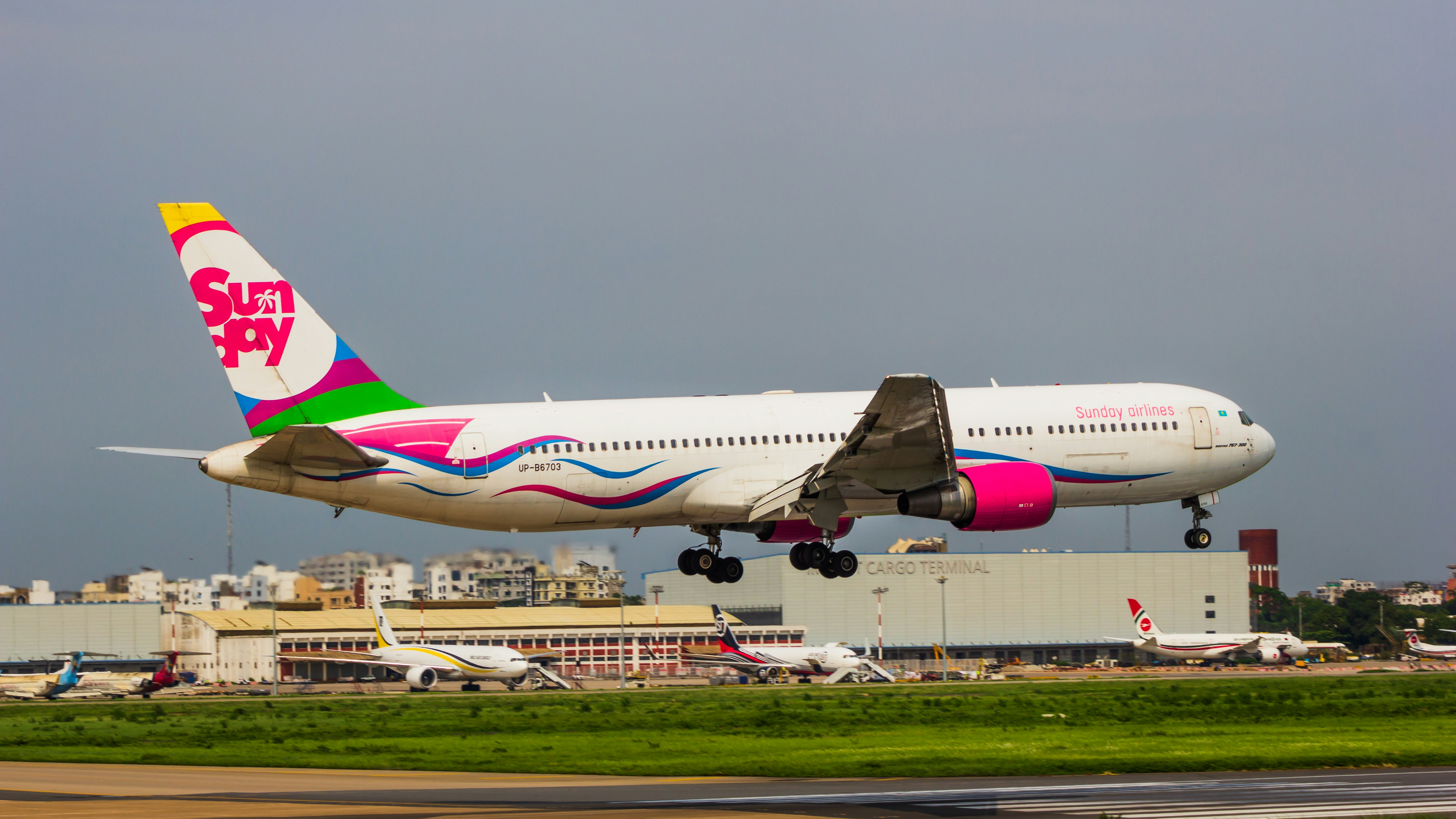 a large jetliner taking off from an airport runway, Sunday Airlines Boeing 767-300ER