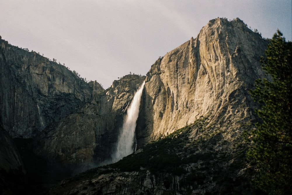 a large waterfall cascading over a mountain side