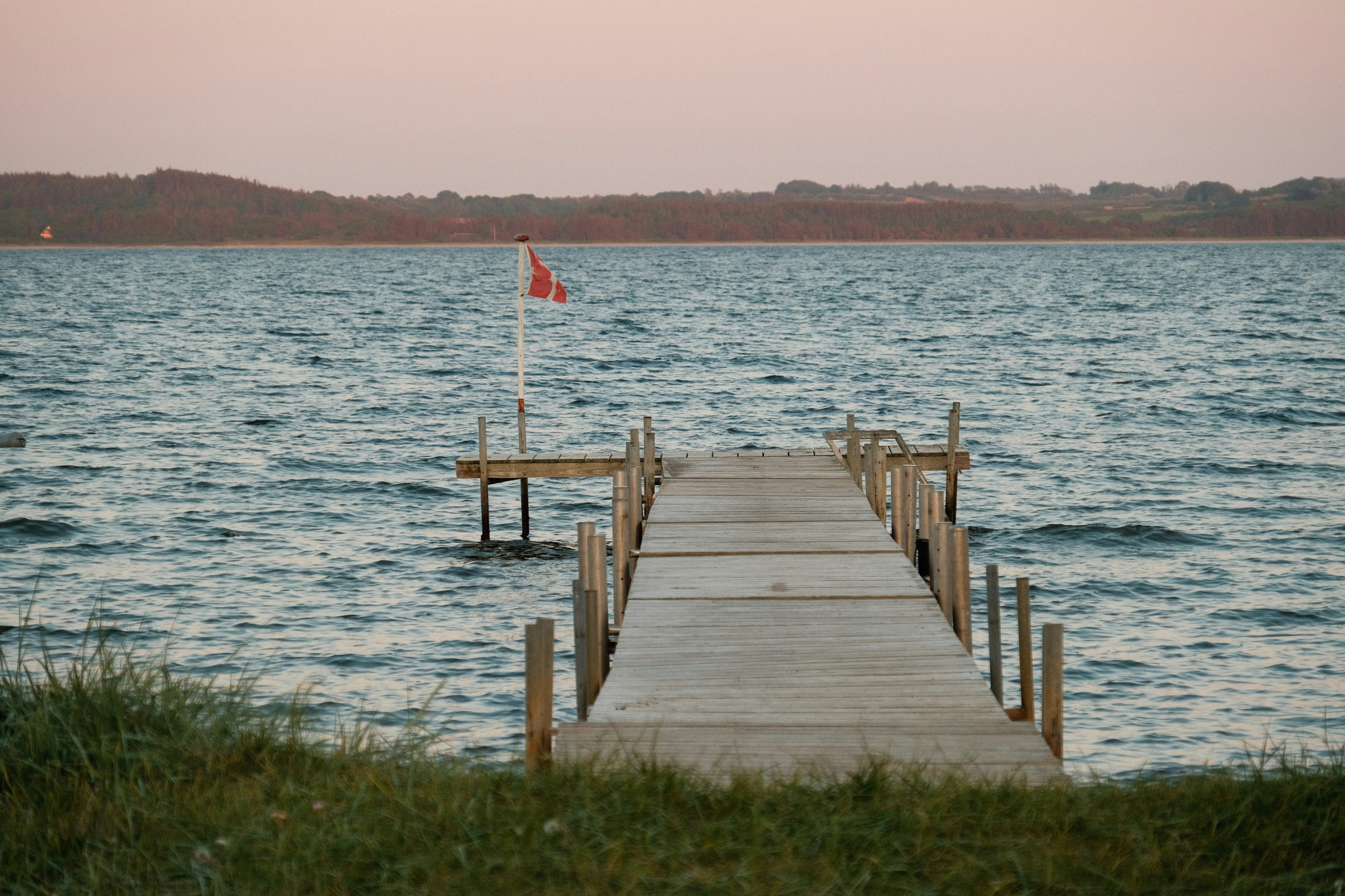 a wooden dock with a flag on top of it