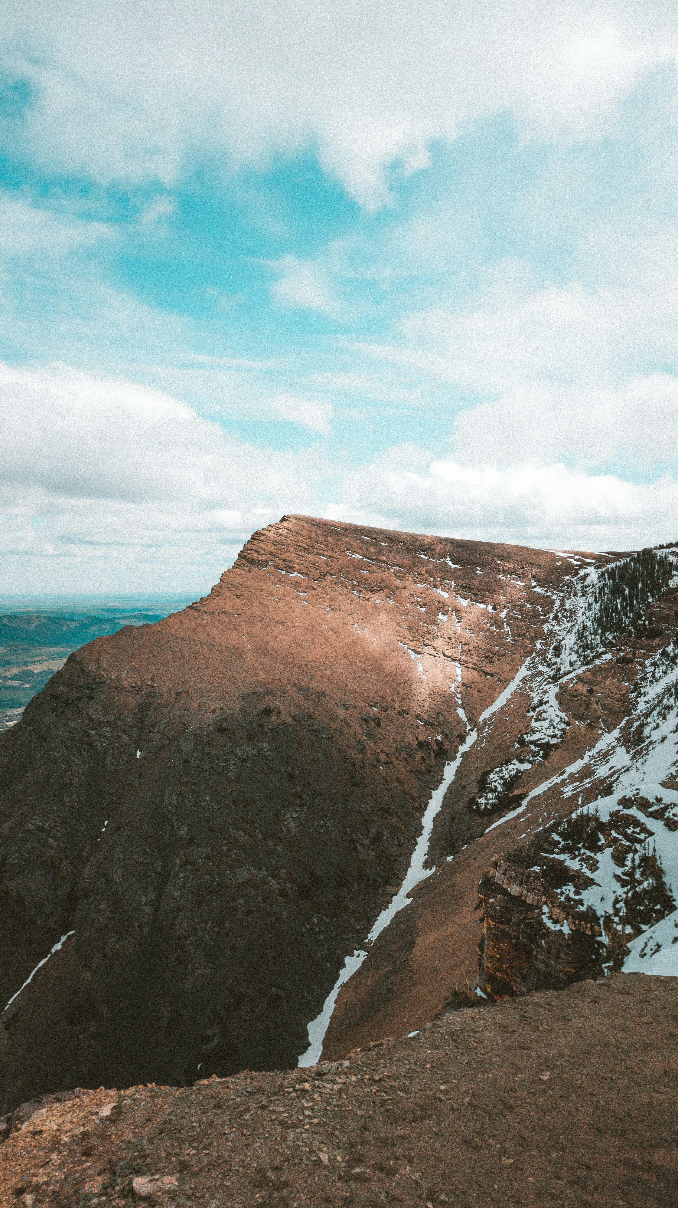a man standing on top of a snow covered mountain