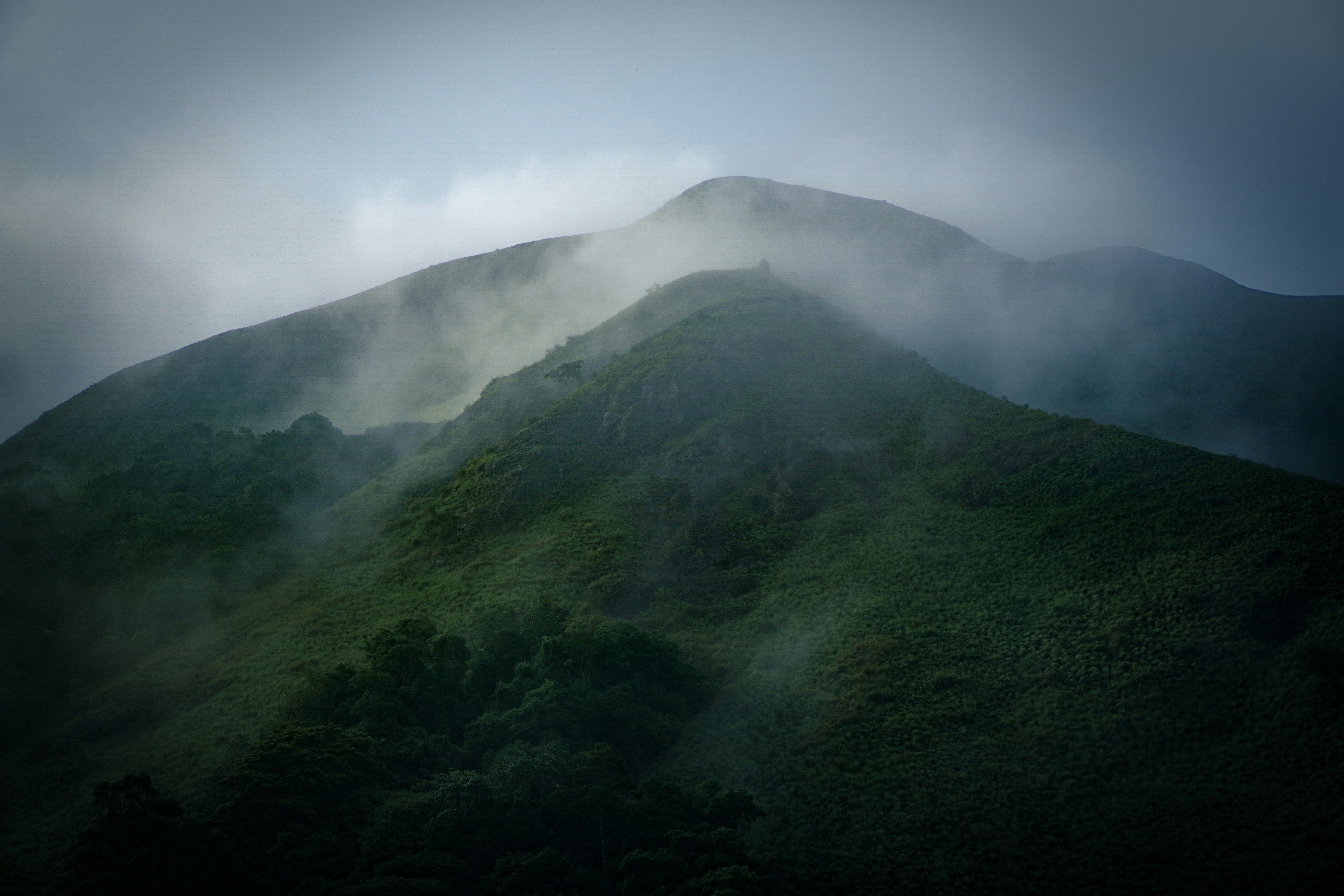 a very tall mountain covered in fog and clouds