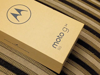 a cardboard box sitting on top of a bed