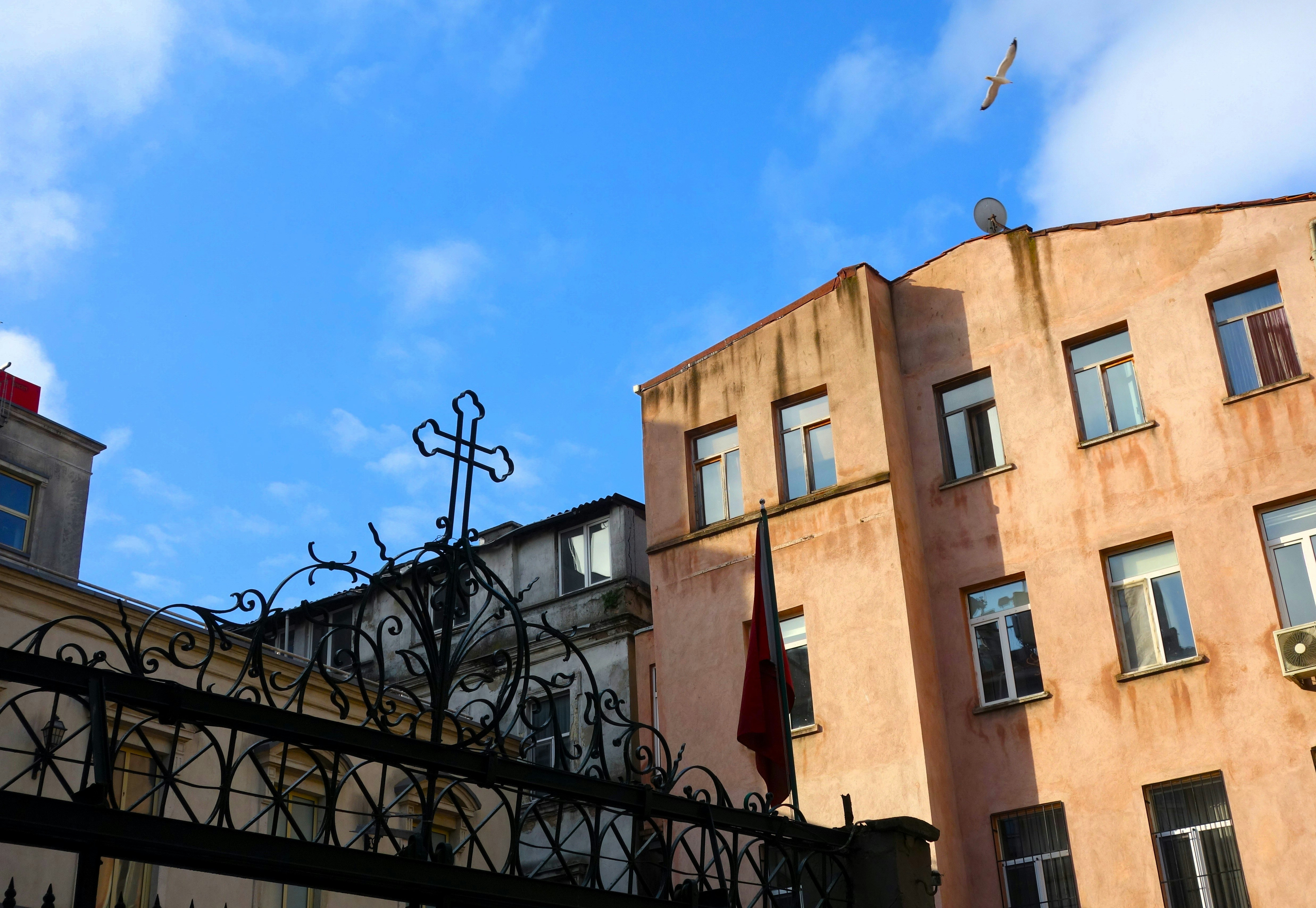 A building with a cross on the top of it photo – Free Building Image on ...
