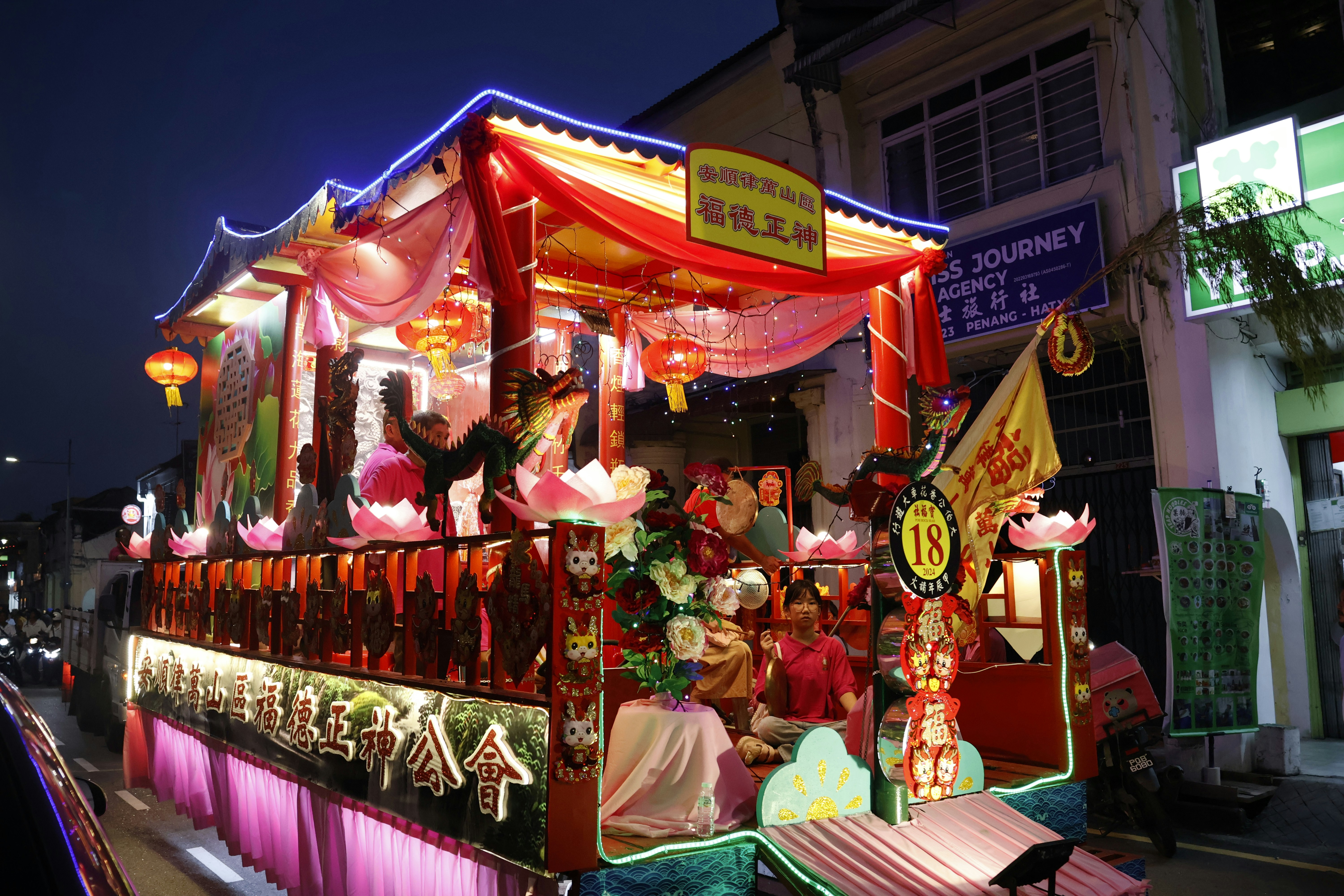 A food cart adorned with lights and decorations is featured in lunar new year videos that use royalty free music for Chinese New Year.