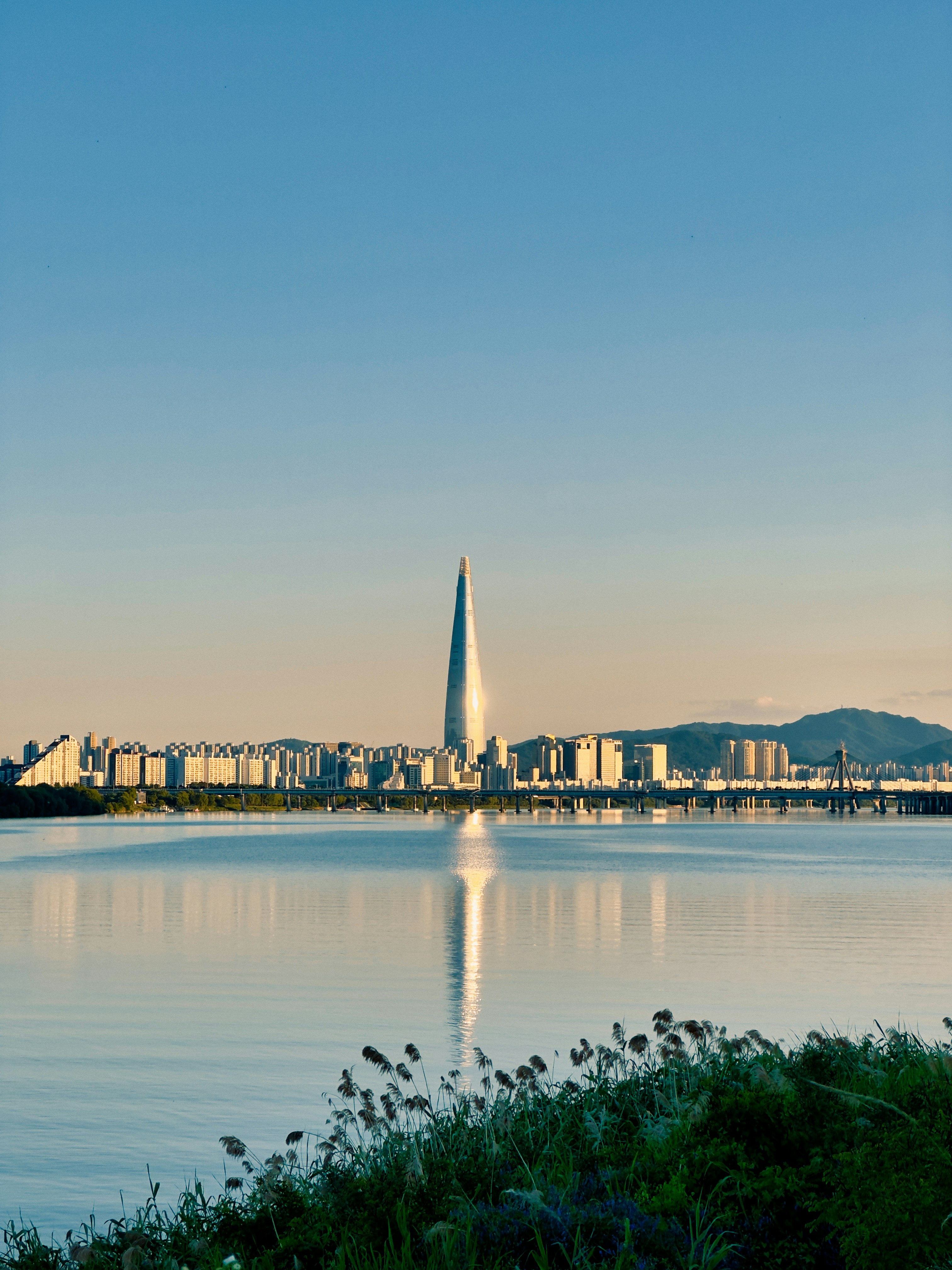a large body of water with a city in the background