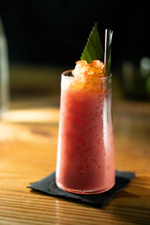 a drink sitting on top of a wooden table