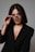 a woman wearing glasses and a black jacket