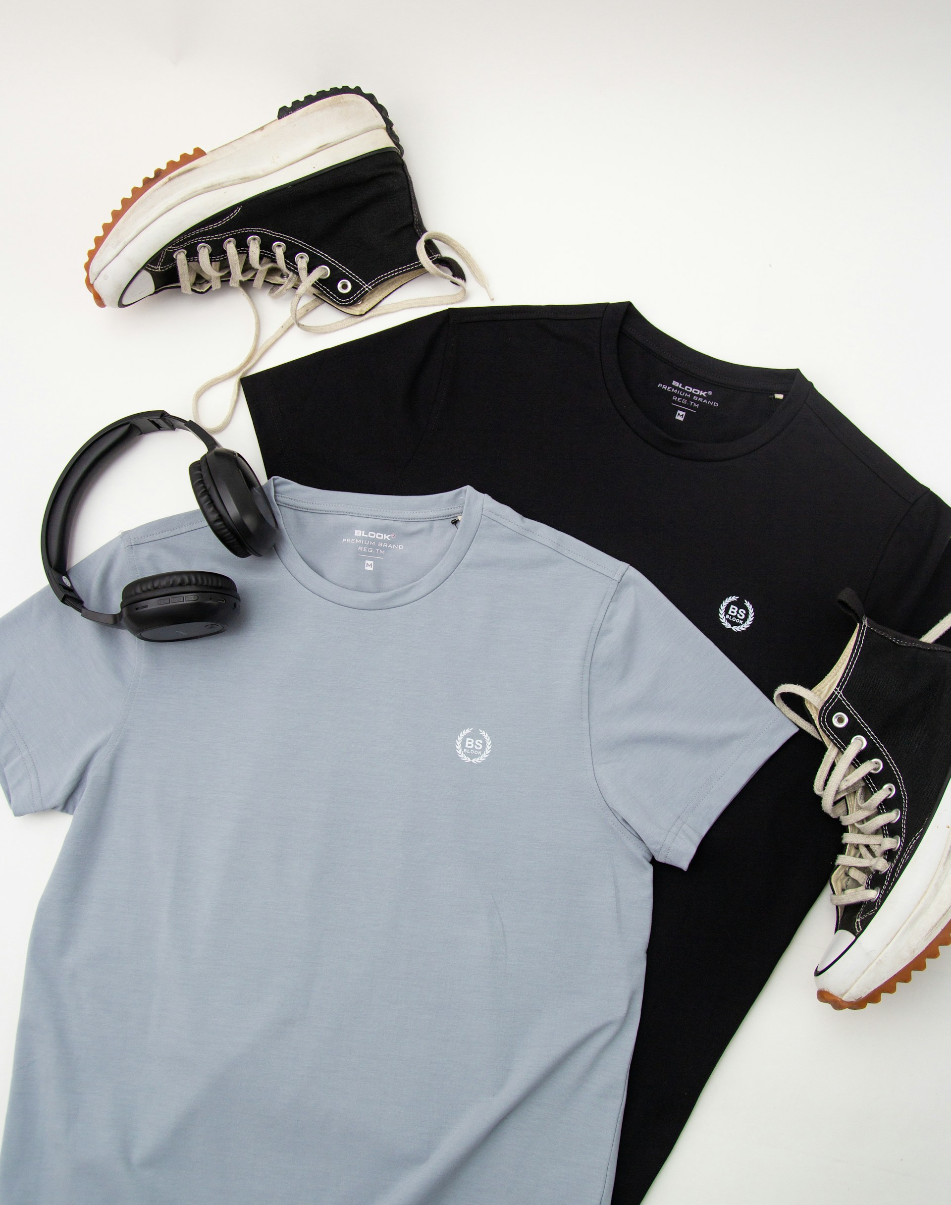 a pair of headphones and a pair of black and grey t - shirts