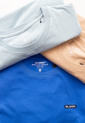 a group of three t - shirts sitting next to each other