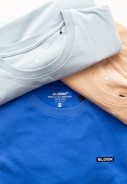 a group of three t - shirts sitting next to each other