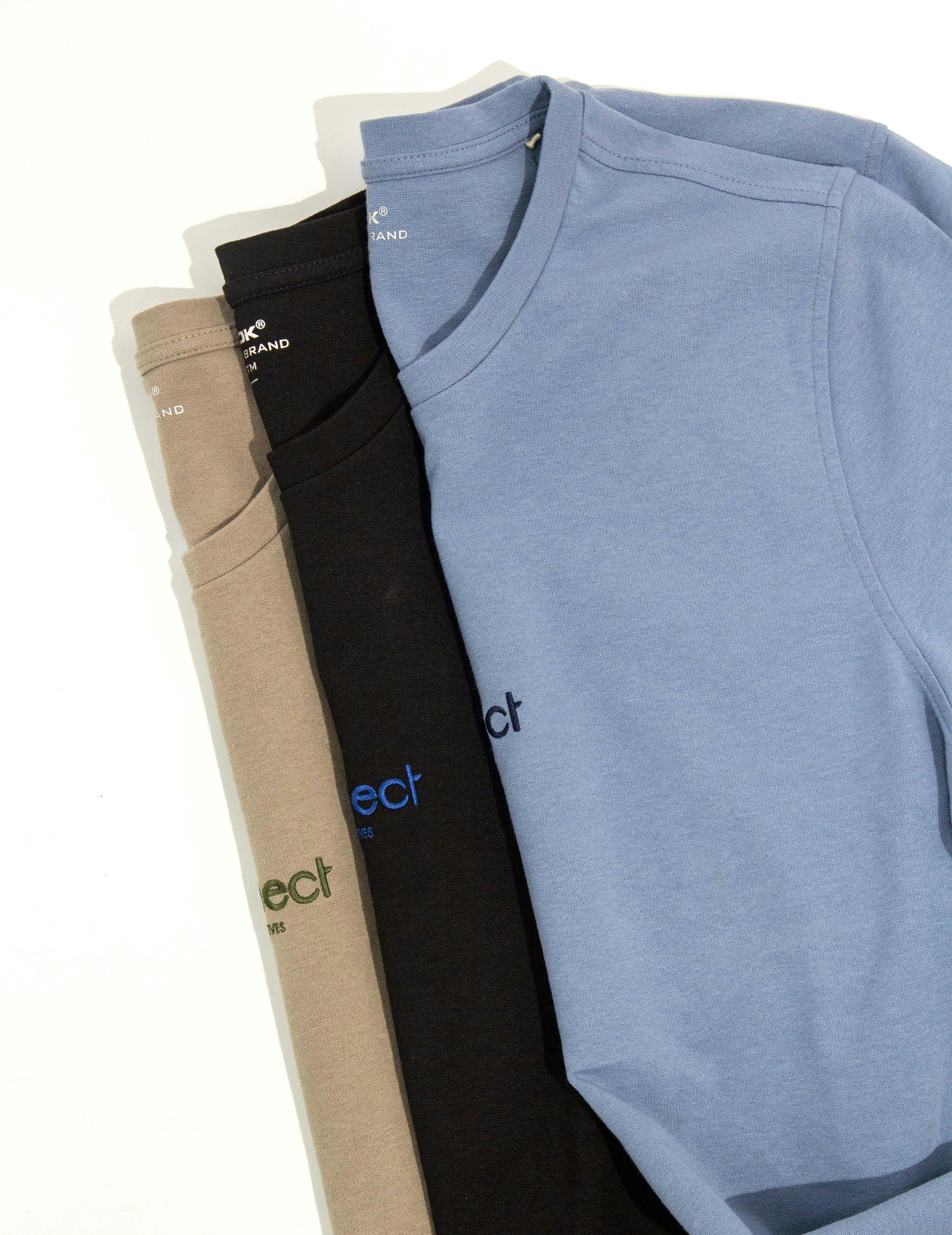 a group of three long sleeved shirts sitting next to each other