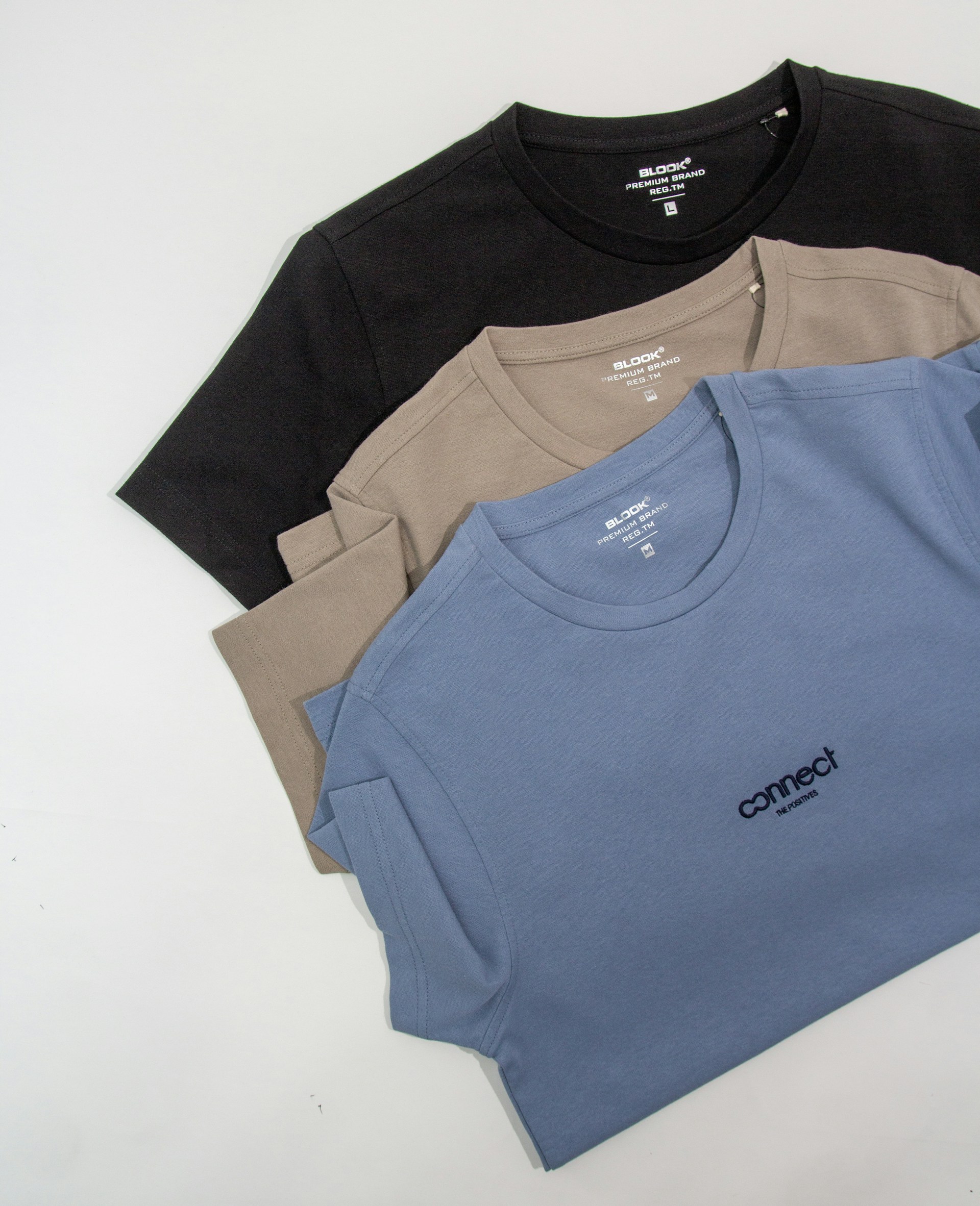 a group of three t - shirts sitting next to each other