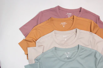 a group of five t - shirts sitting on top of each other