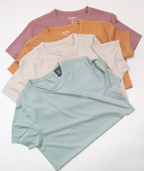 a group of five t - shirts sitting on top of each other