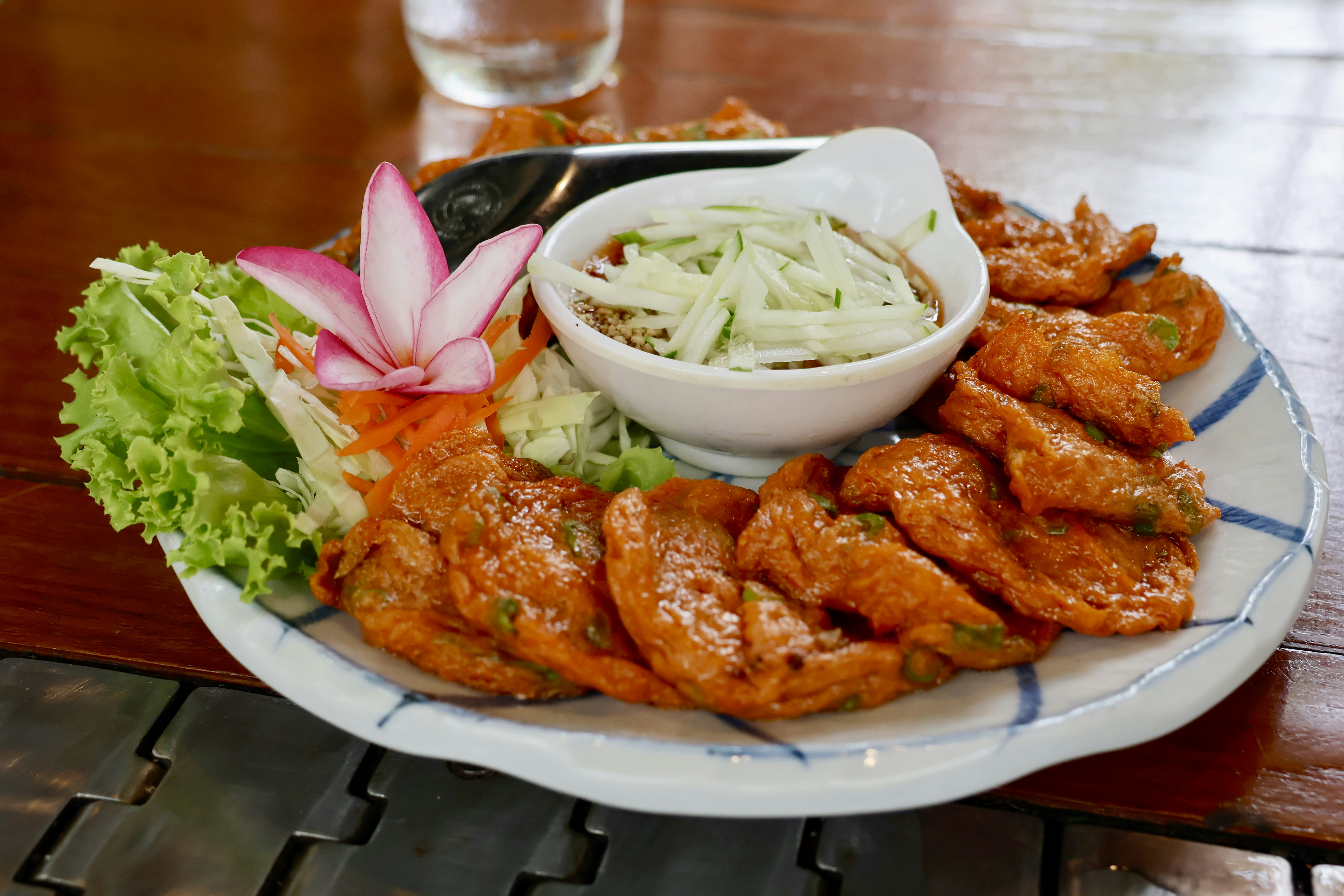 a plate of food with chicken wings and coleslaw