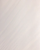 a man riding a snowboard down the side of a snow covered slope