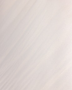 a man riding a snowboard down the side of a snow covered slope