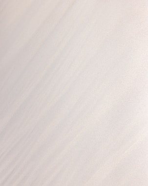 a man riding a snowboard down the side of a snow covered slope