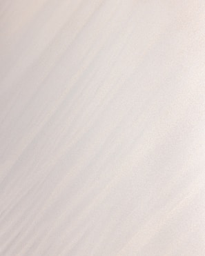 a man riding a snowboard down the side of a snow covered slope