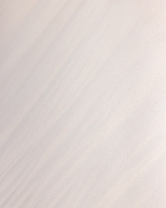 a man riding a snowboard down the side of a snow covered slope