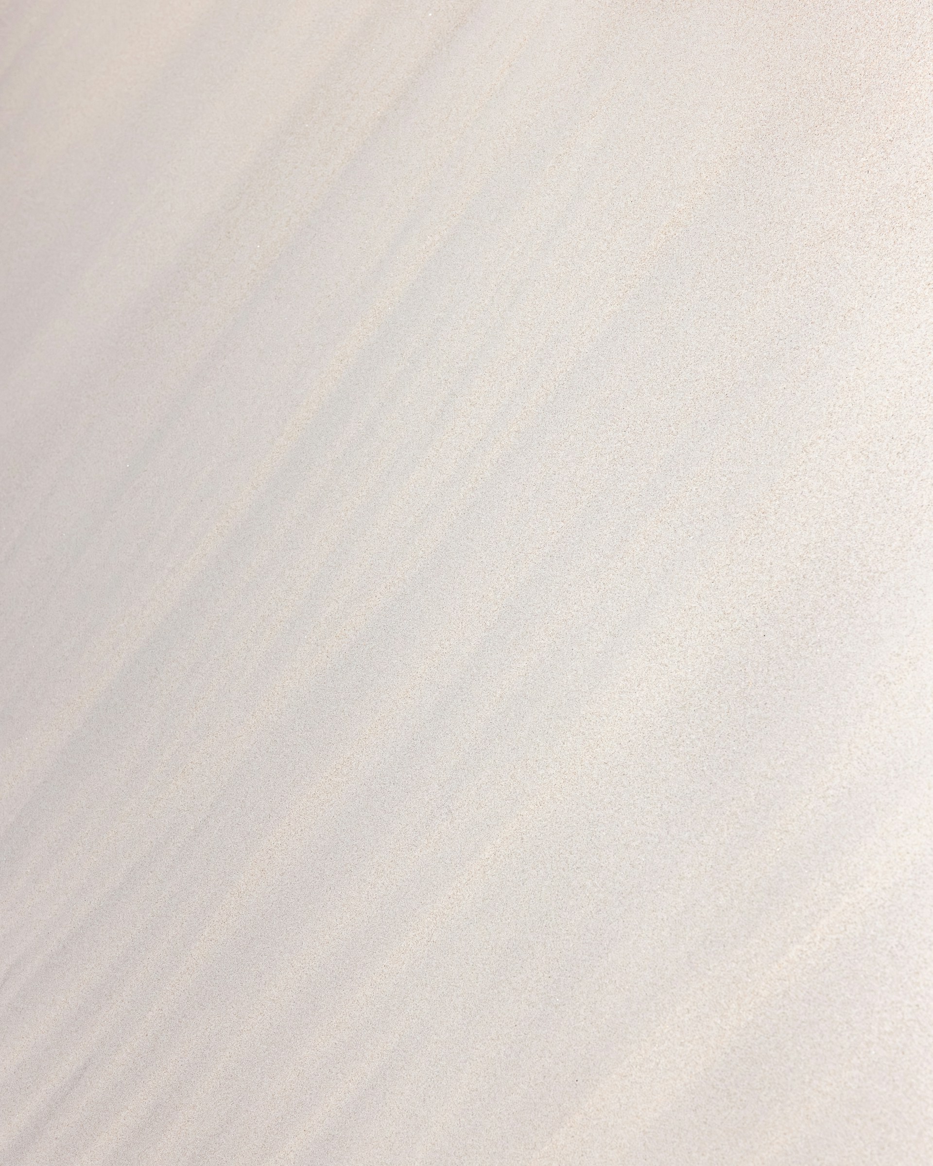 a man riding a snowboard down the side of a snow covered slope