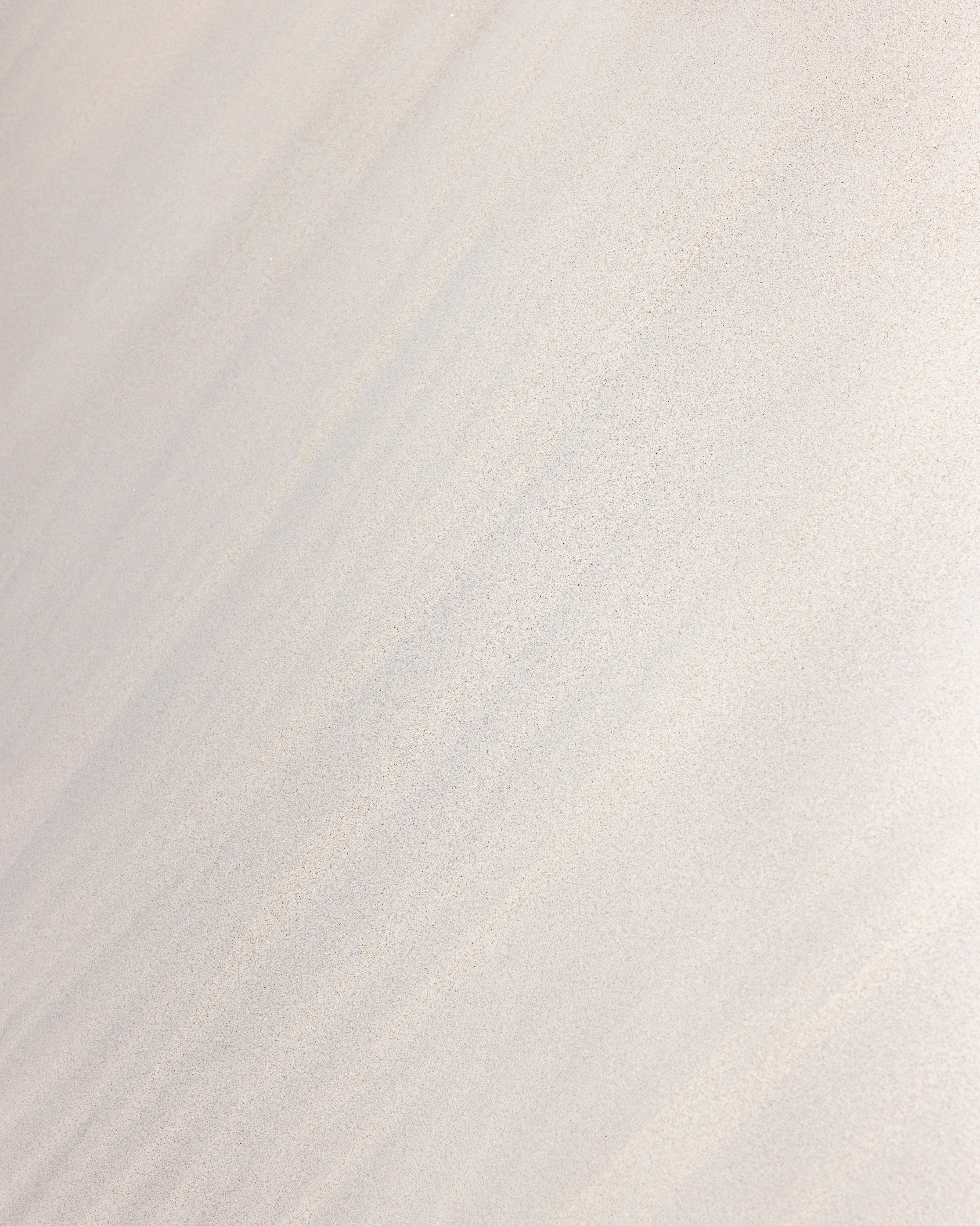 a man riding a snowboard down the side of a snow covered slope