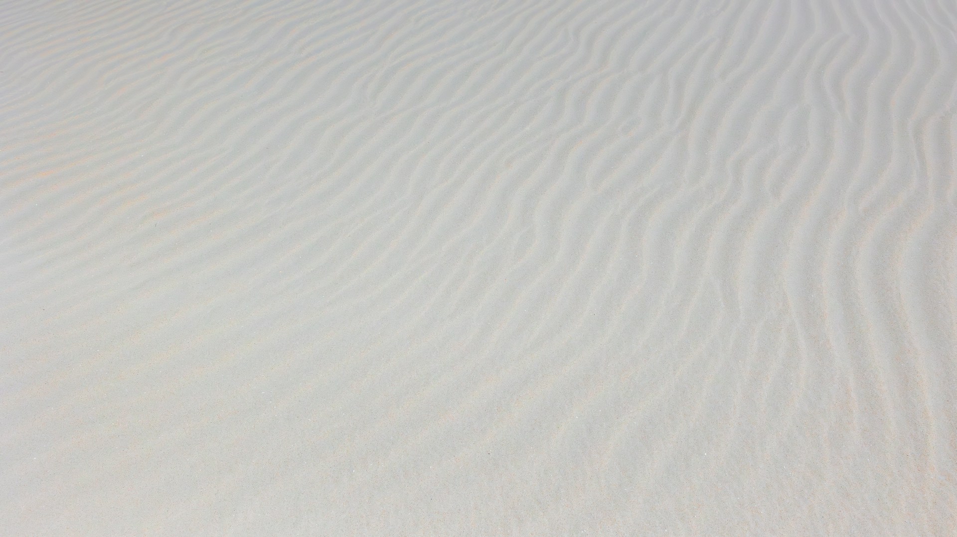a person riding a snowboard down a snow covered slope