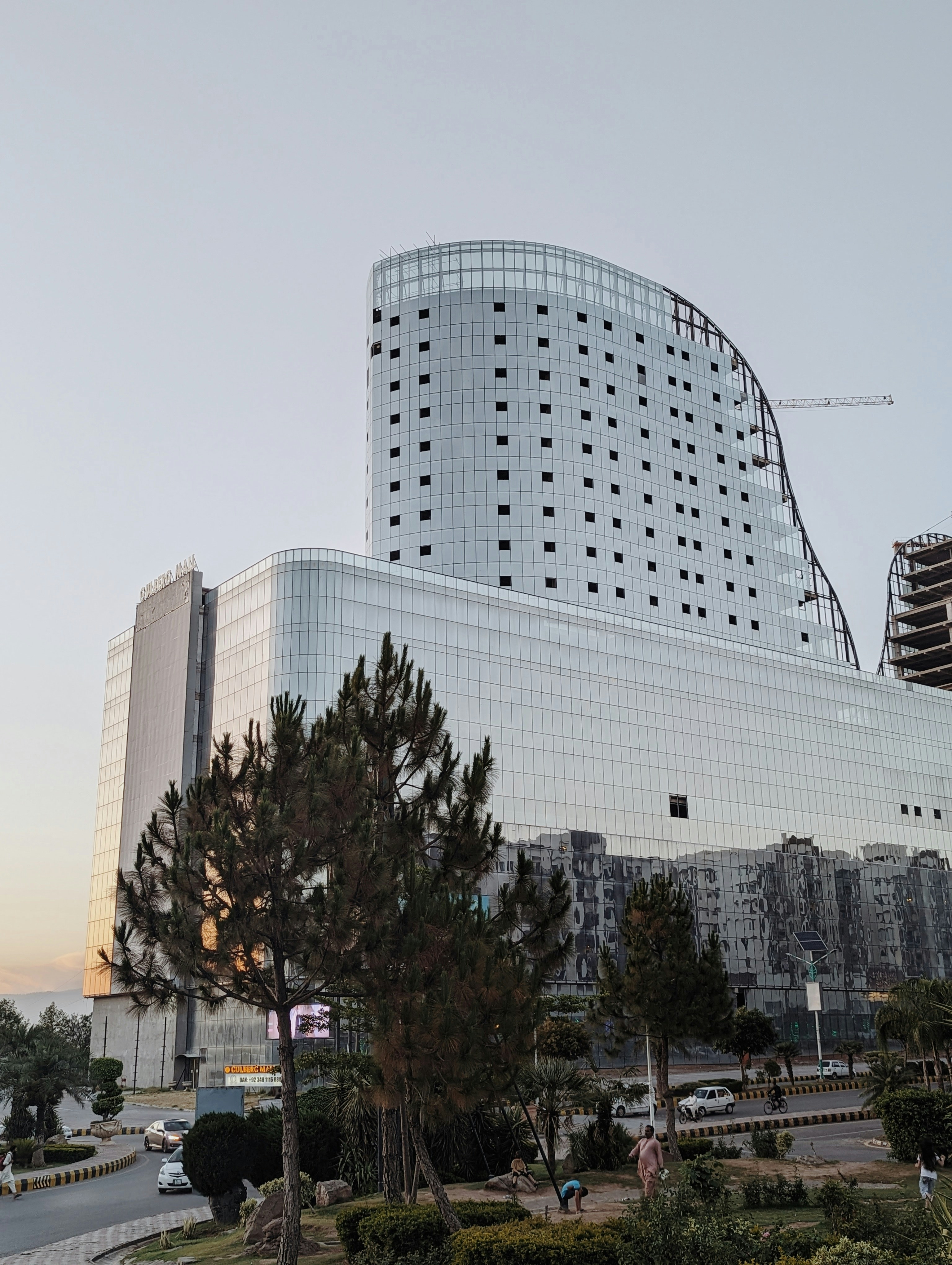 a large white building with many windows next to a street