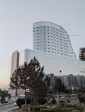 a large white building with many windows next to a street