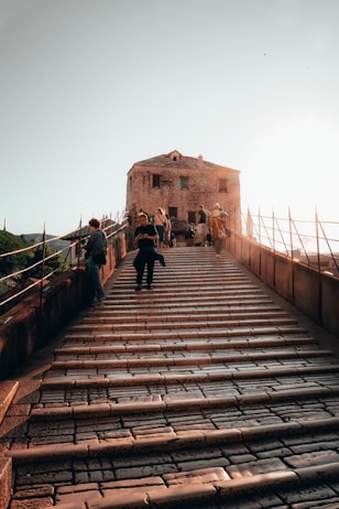 a group of people walking up a set of stairs
