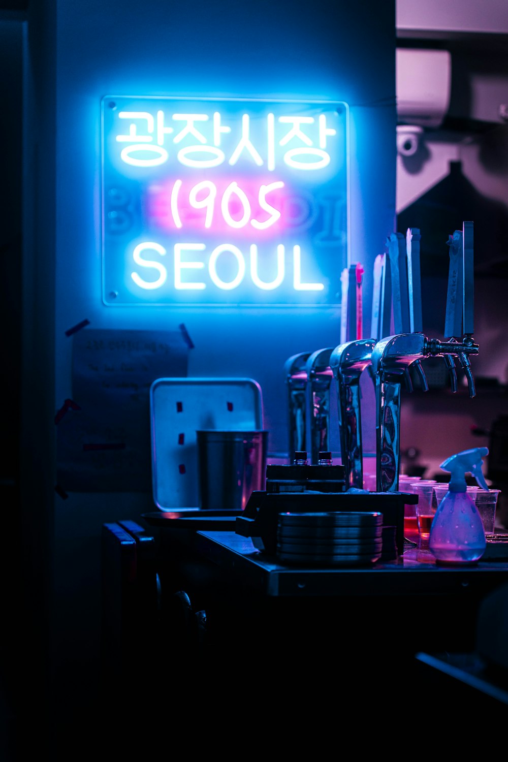 a bar with a neon sign in the background
