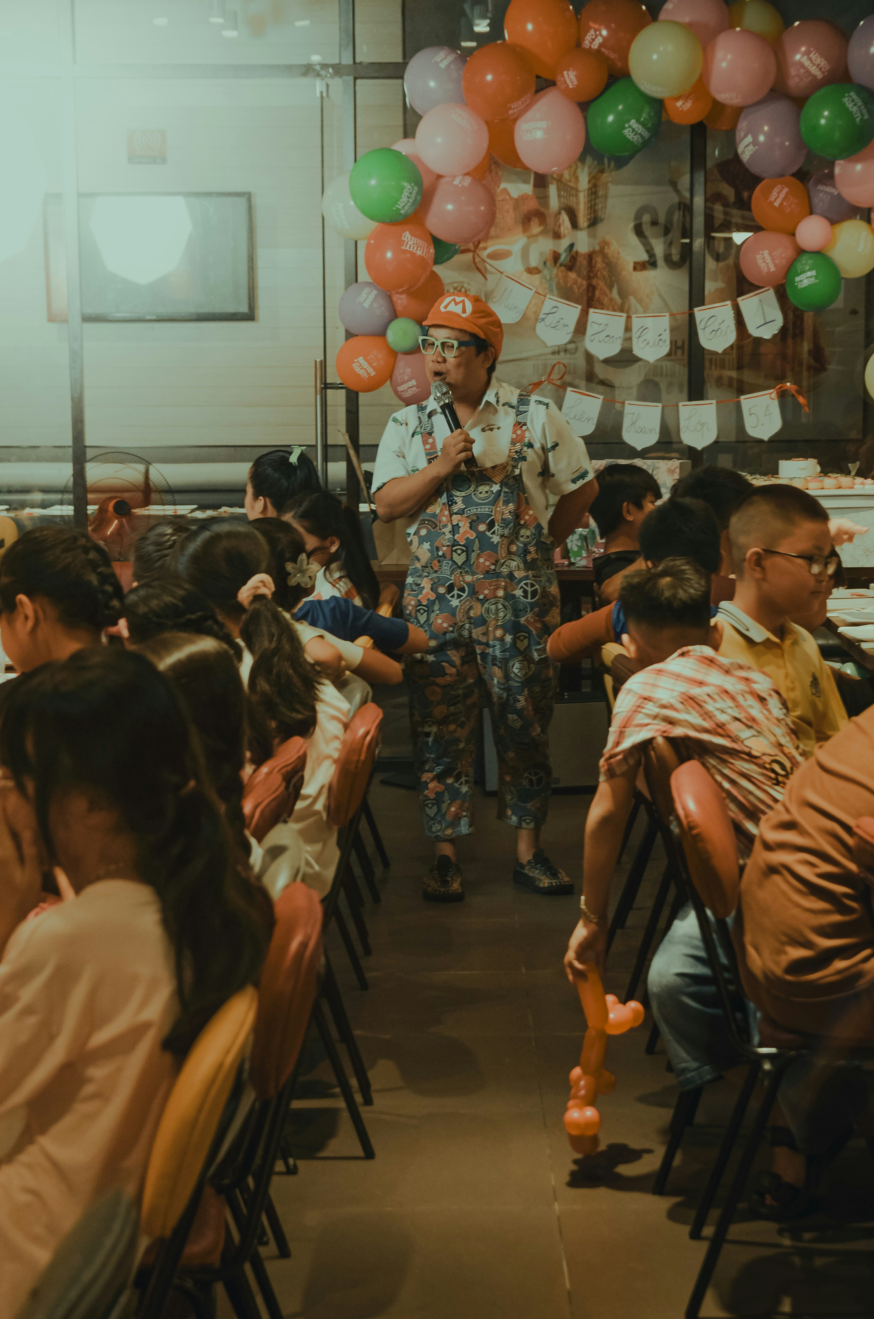 a woman standing in front of a room filled with people